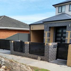 036 Metal Slat Fence With Brick Posts and Footing